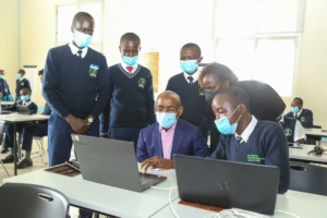 Safaricom CEO Peter Ndegwa with M-PESA Foundation Academy students