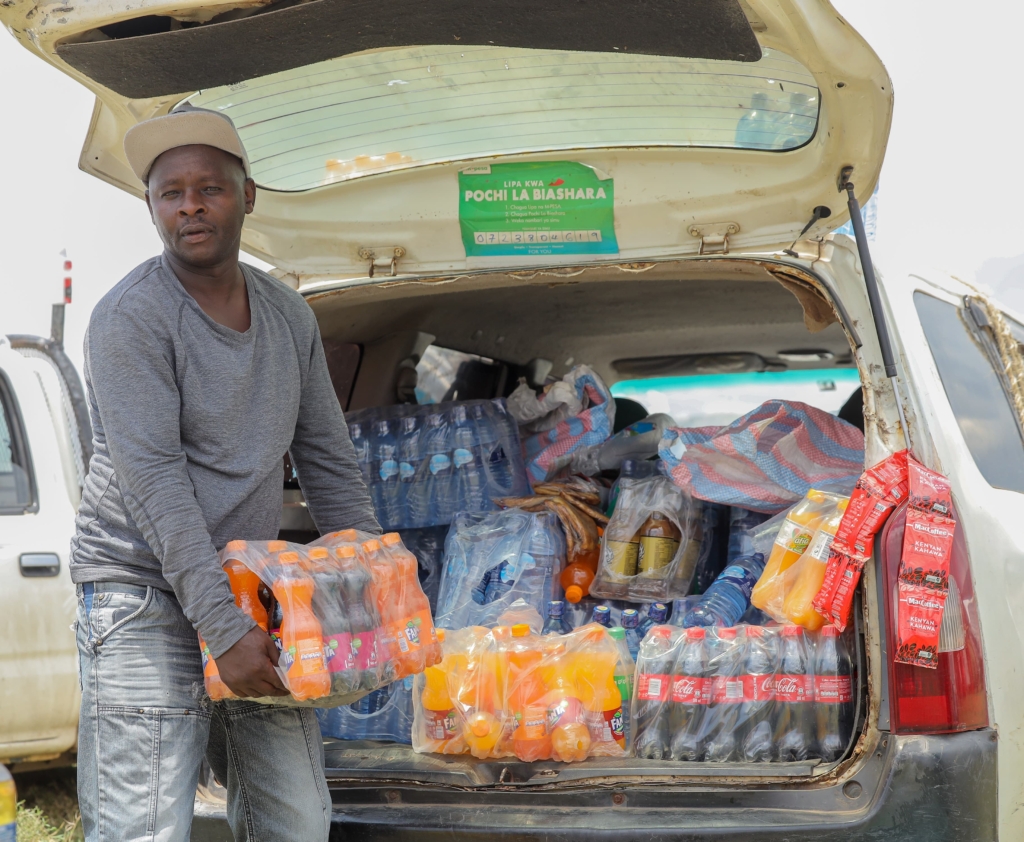 Vendors at WRC Safari Rally in Naivasha using cashless payment through M-PESA to serve rally fans efficiently, ensuring fast, secure, and seamless transactions.
