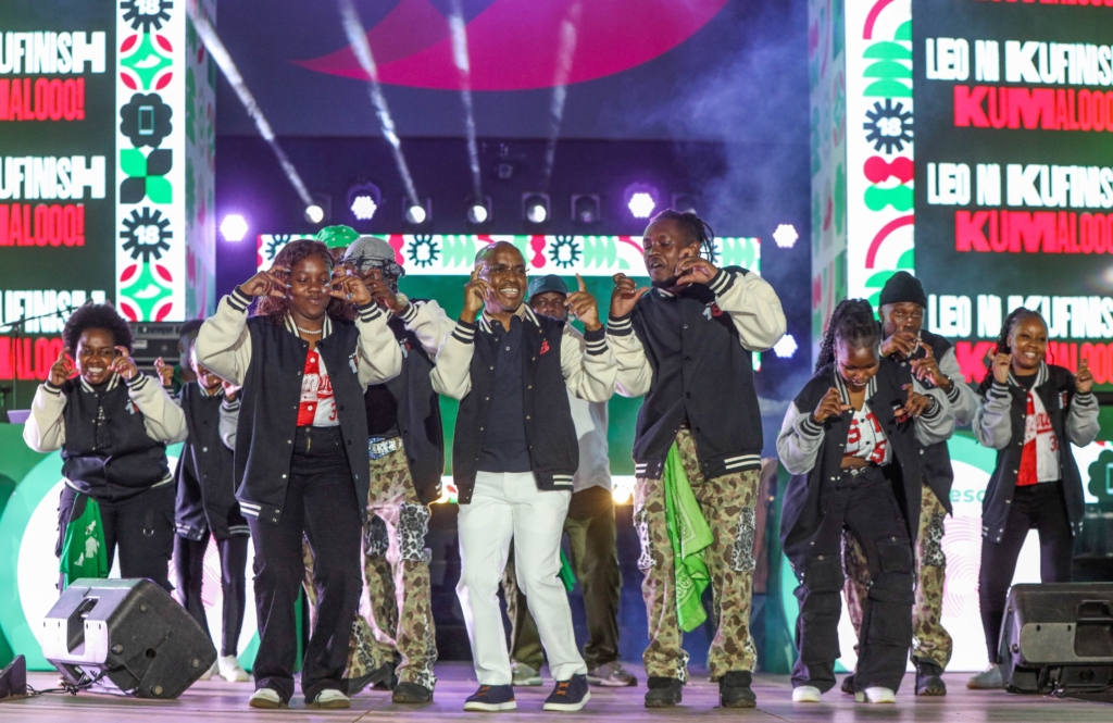 Peter Ndegwa, CEO of Safaricom, dancing with energetic performers at the M-PESA 18 Concert, celebrating 18 years of M-PESA with music and entertainment.