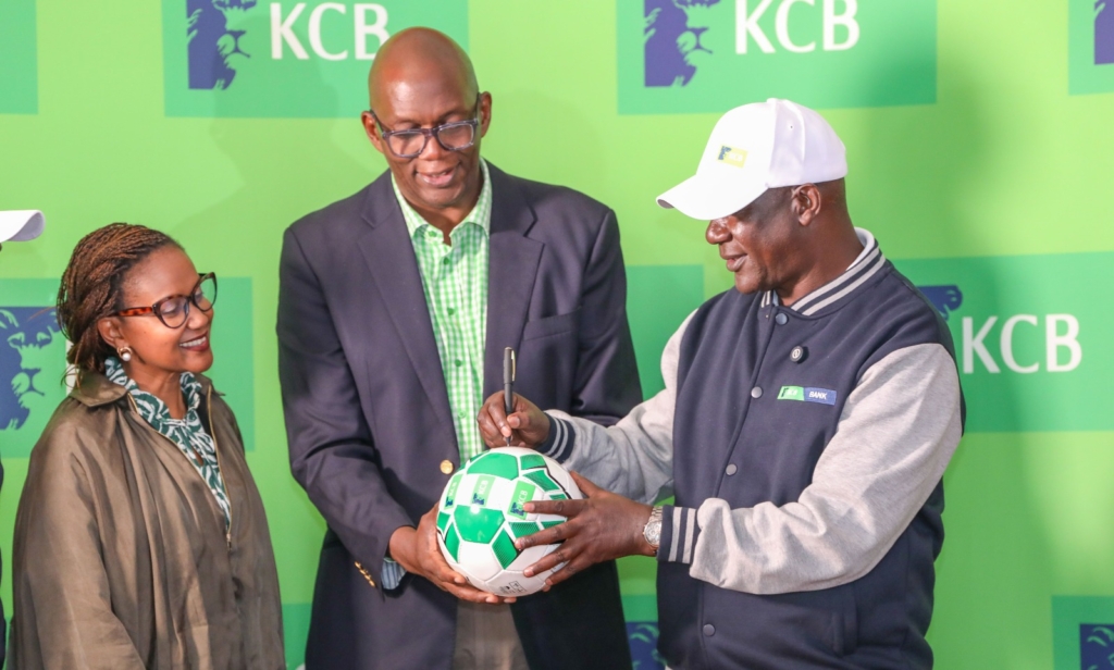 KCB FC patron Azu Ogola presents a football to the newly signed KCB FC coach Robert Matano signs moments.