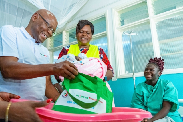 Joseph Ogutu, Safaricom Foundation Chairman, and H.E. Hon. Gladys Wanga, CBS, Governor of Homa Bay County, present a Mama Pack from the M-Pesa Foundation to Ivene Obuya, a new mother, at the Homa Bay County Referral and Teaching Hospital during the M-Pesa Foundation medical camp in Homa Bay Joseph Ogutu, Safaricom Foundation Chairman, and H.E. Hon. Gladys Wanga, CBS, Governor of Homa Bay County, present a Mama Pack from the M-Pesa Foundation to Ivene Obuya, a new mother, at the Homa Bay County Referral and Teaching Hospital during the M-Pesa Foundation medical camp in Homa Bay