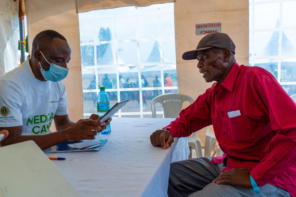 Clement Abode, a resident of Homa Bay, registers for the SHA medical cover during free M-Pesa Foundation Medical camps in Homa Bay.
