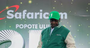 Moses Elekana, winner of KES 1 million in the Shangwe @25 campaign, poses for a photo with his cheque during the award ceremony held at Kangundo Road Market in Nairobi.