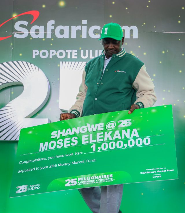 Moses Elekana, winner of KES 1 million in the Shangwe @25 campaign, poses for a photo with his cheque during the award ceremony held at Kangundo Road Market in Nairobi.